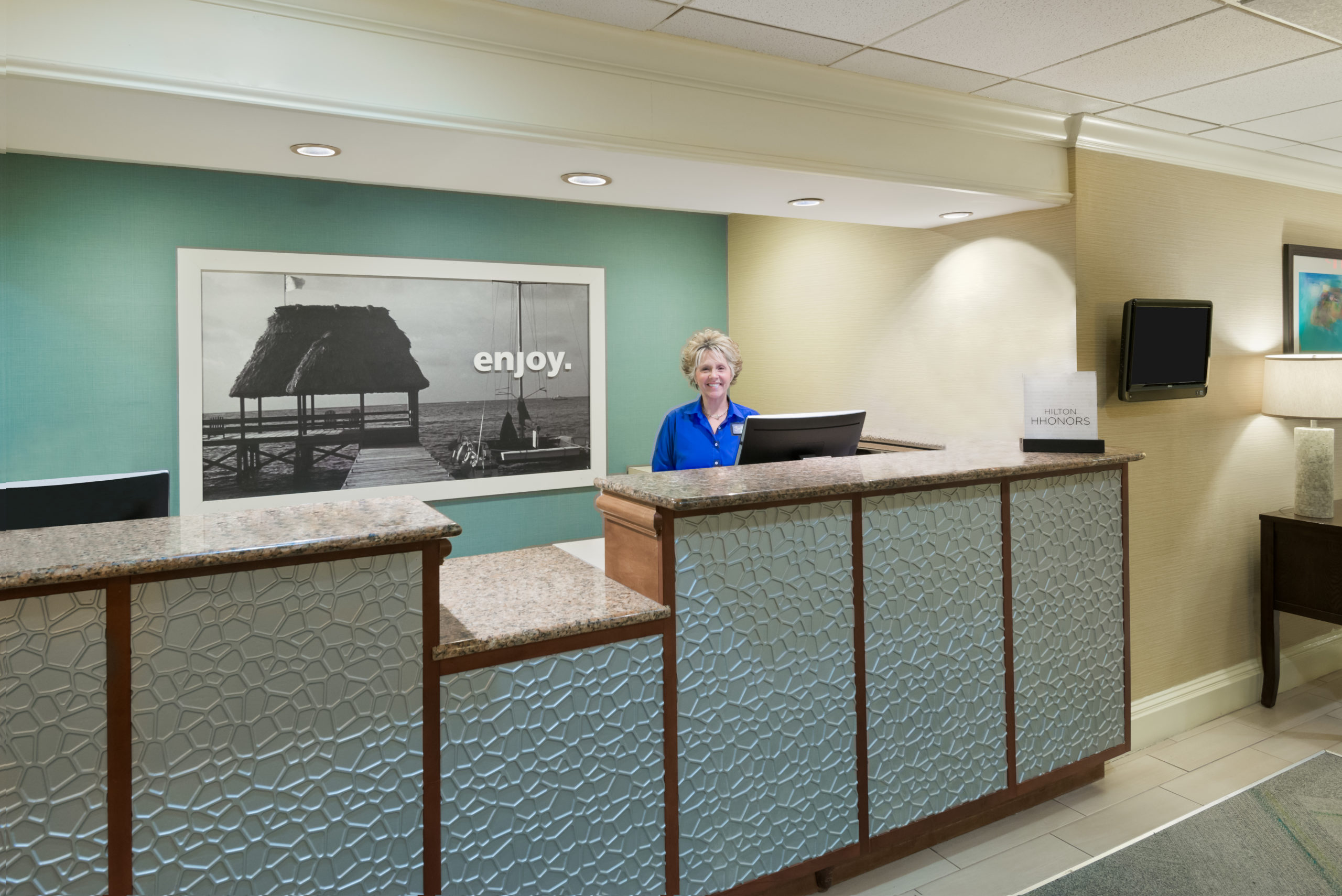 Front desk with smiling front desk agent